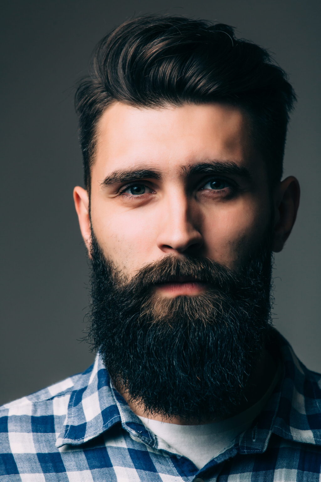 portrait masculinity portrait handsome young bearded man while standing against grey wall (1)