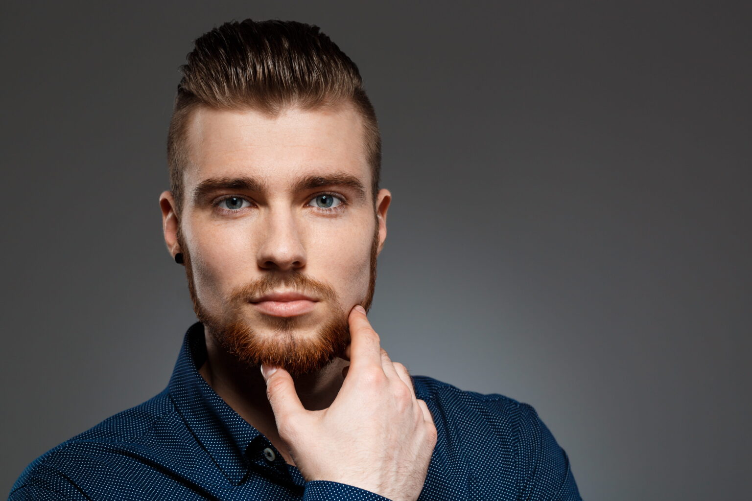 young successful businessman posing dark wall (1)